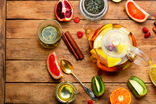 Teapot with citrus fruits