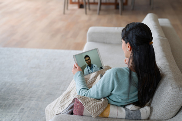 Woman at home talking to her doctor on a video call